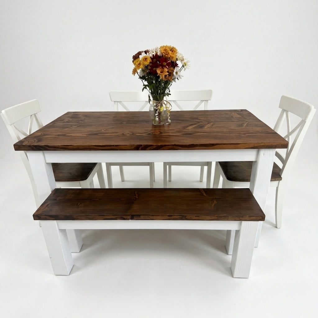 Wooden dining table with white chairs and a bench on a white background